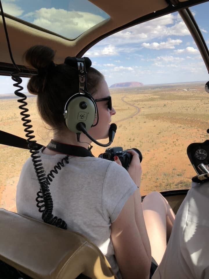 Woman in the front seat of a helicopter