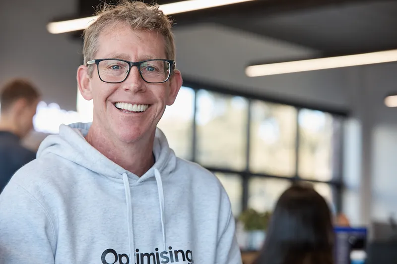 DanM smiling in Optimising grey hoodie