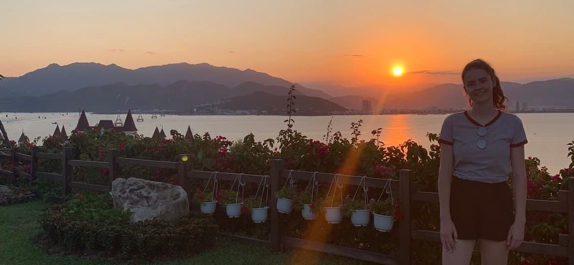 Woman posing with plants and beautiful sunset