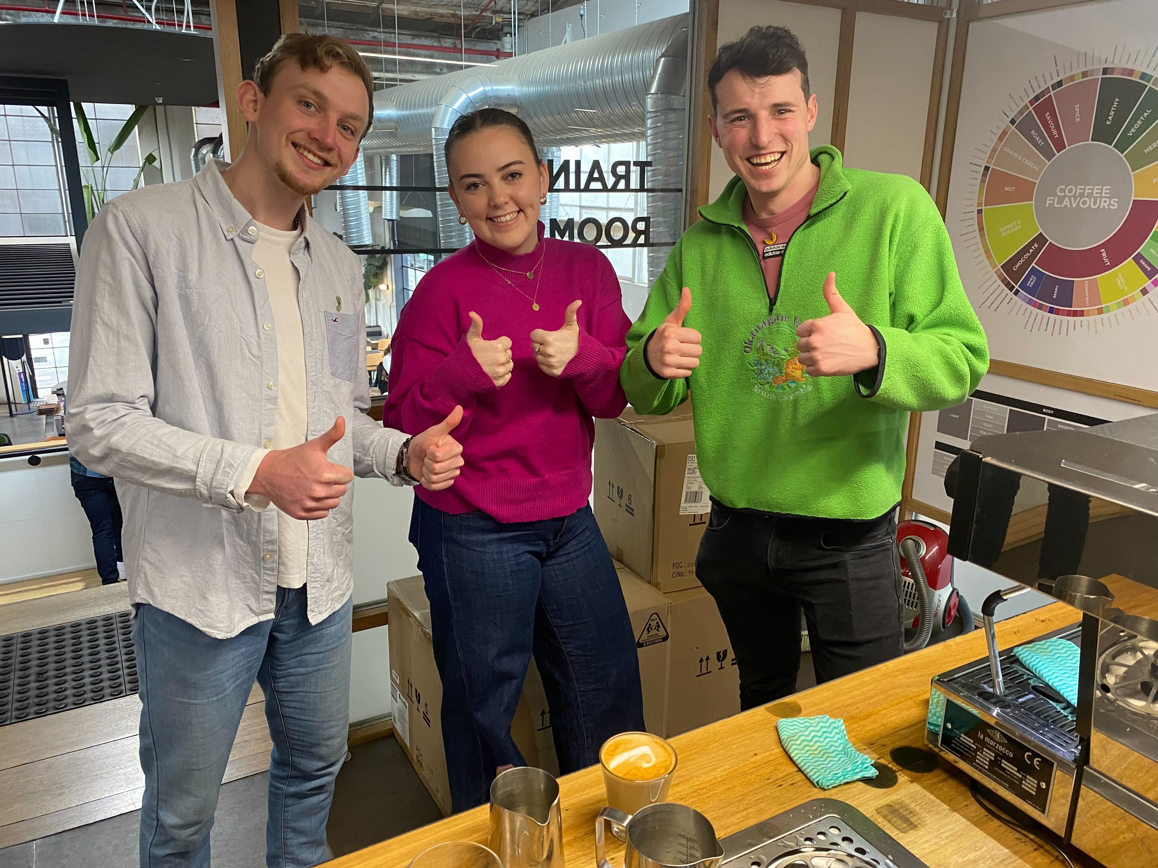 Marcus, Isabelle and Andrew give a thumbs up at the coffee workshop